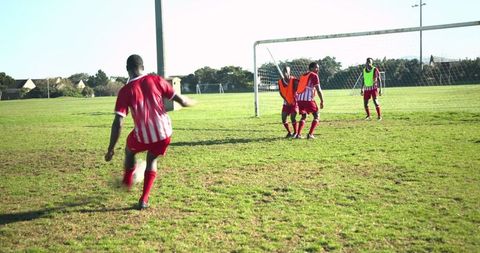 Youth Soccer Players Competing on Sunlit Field