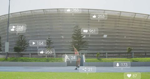 Athlete interacting with social media icons at modern stadium
