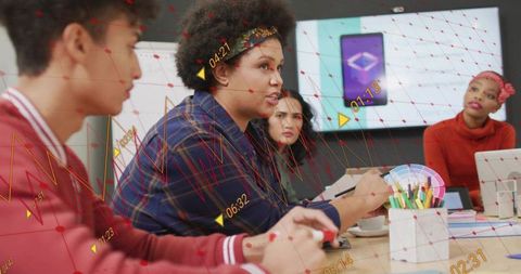 Diverse Team Collaboration in Modern Office with Graphs Overlay