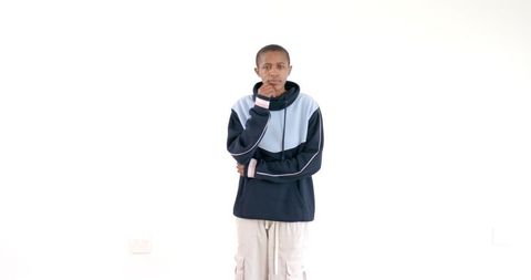 Confident Young Man in Stylish Hoodie Against White Background