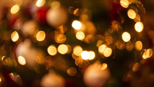 Golden christmas bokeh lights with blurred baubles creating cozy holiday glow