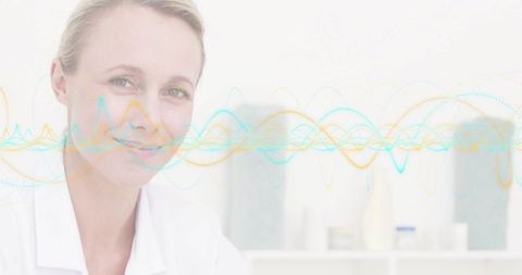 Smiling female clinician wearing lab coat communicating health data with waveform overlay
