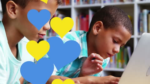 Diverse Boys Engaging with Laptop in Classroom Setting