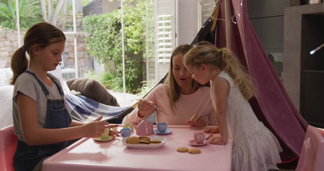 Mother and Daughters Enjoying Cozy Indoor Tea Party - Download Free Stock Images Pikwizard.com