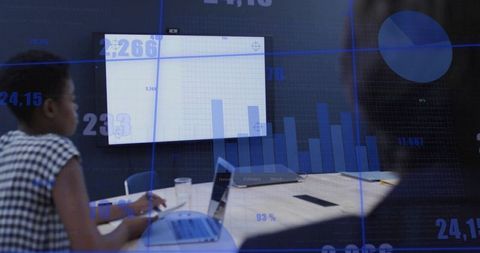 Professional team analyzing data with digital interface graphics