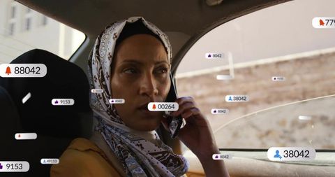 Woman wearing headscarf talking on phone in backseat with floating notification bubbles