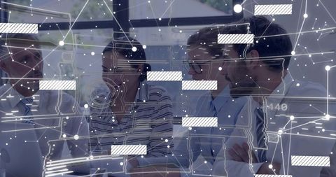 Team analyzing digital network diagrams in modern office