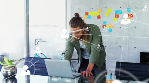 Businessman Working on Laptop in Modern Office with Network Graphics