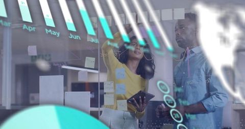 Collaborative Data Planning on Glass Wall with Sticky Notes, Tablet and Dashboard