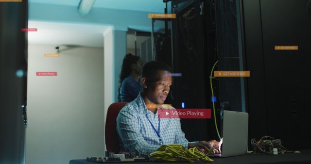 Man working on laptop in server room with digital interface overlays - Download Free Stock Images Pikwizard.com