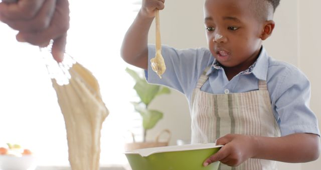 Child mixing dough in kitchen setting, engaging in a fun and educational baking activity. Ideal for content related to parenting, kids' activities, learning at home, nutrition education, and family bonding. Showcases hands-on learning and creativity in the kitchen.