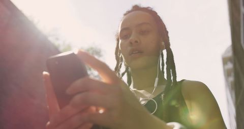 Young Woman Using Smartphone with Headphones Outdoors - Download Free Stock Images Pikwizard.com