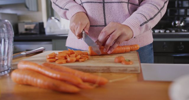 Woman Chopping Carrots in Modern Kitchen - Download Free Stock Images Pikwizard.com