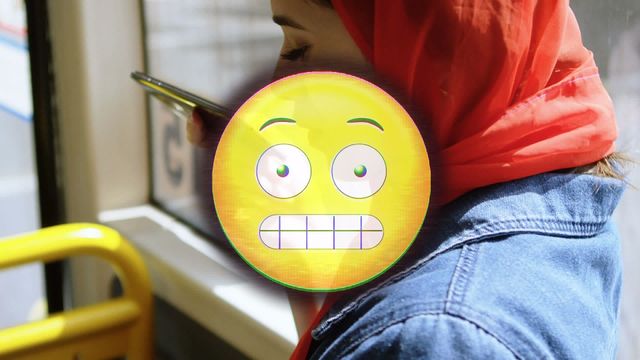 This digital animation with a scared emoji overlaying a Muslim woman in a red hijab using her smartphone is ideal for social media, communication, and tech concepts. It can be used in advertisements or articles discussing multicultural interactions, digital communications, or the impact of emojis in modern text.