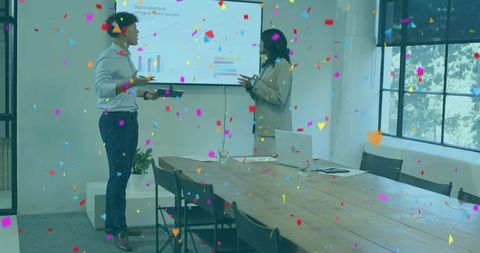 Presenting and celebrating project success with confetti in modern boardroom meeting