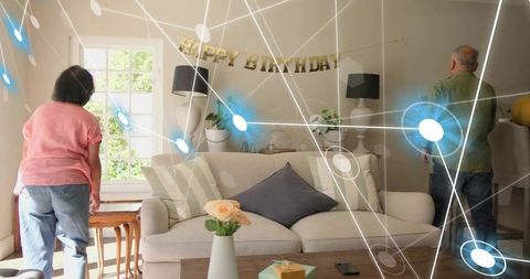 Older couple celebrating birthday in living room with smart home network overlay
