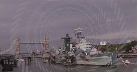 Hms belfast docked on thames with iconic tower bridge view