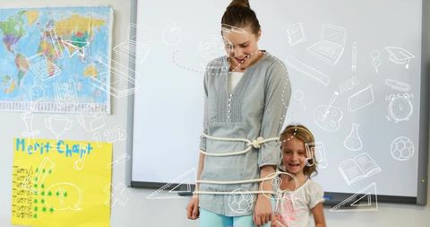 Teacher demonstrating playful trust exercise with student in bright elementary classroom