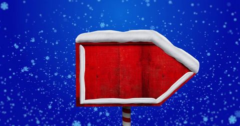 Wooden Arrow Sign Covered in Snow on Winter Day