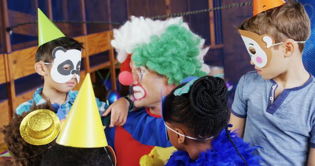 A clown entertains a diverse group of children at a party, with copy space. Joy and amusement are evident as the kids, wearing party hats and masks, engage with the performer.