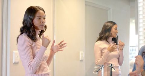 Joyful african american friends communicating in bright bathroom setting