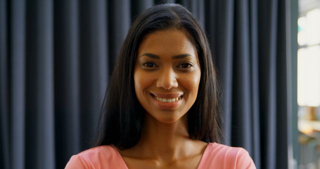 Confident Young Woman Smiling in Office Setting - Download Free Stock Images Pikwizard.com