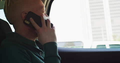 Man Wearing Face Mask Talking on Smartphone in Car During Pandemic