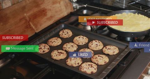 Fresh chocolate chip cookies on baking tray with social media notification overlays