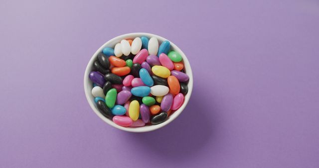 Colorful Jelly Beans in White Bowl on Purple Background - Download Free Stock Images Pikwizard.com