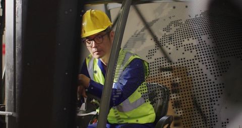 Determined Forklift Operator Navigating Industrial Warehouse