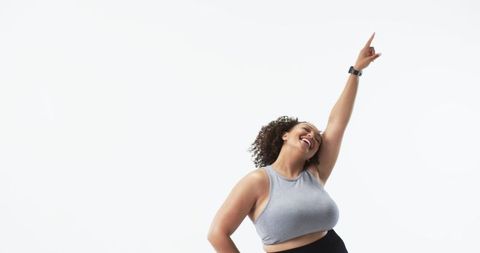 Joyful Plus Size Woman Dancing in Bright Studio