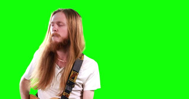 Guitarist playing electric guitar on green screen