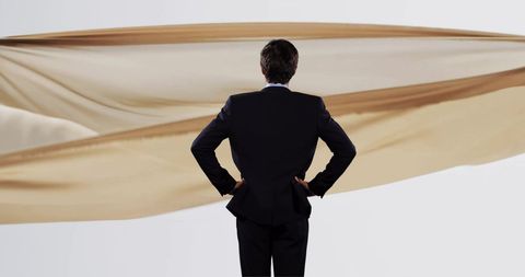 Businessman contemplating floating cloth display