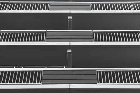 Monochrome perspective of modern condo building facade with balconies
