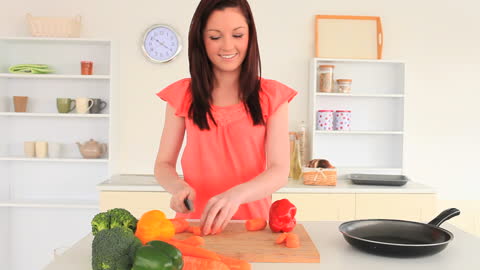 Smiling Woman Preparing Vegetables in Modern Kitchen