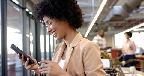 Confident Entrepreneur Engaged on Smartphone in Modern Casual Office - Download Free Stock Images Pikwizard.com