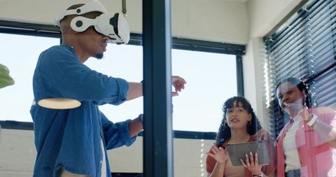 African american team collaborating with vr headset and tablet in modern office for design