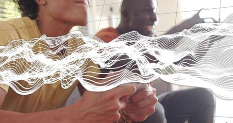 Friends playing video games on couch with dynamic white waveform overlay grid graphic