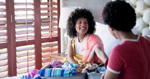 Joyful Moments as Friends Enjoy Tech and Chat at Home