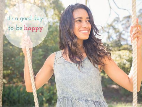Smiling woman on swing embracing joyful outdoor day