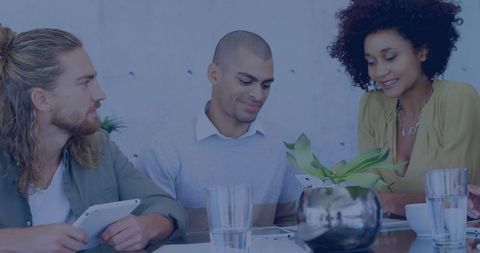 Creative team collaborating with tablets at modern minimalist office meeting