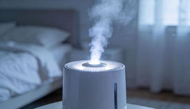 Ultrasonic humidifier emitting gentle mist with led ring on nightstand, minimalist bedroom
