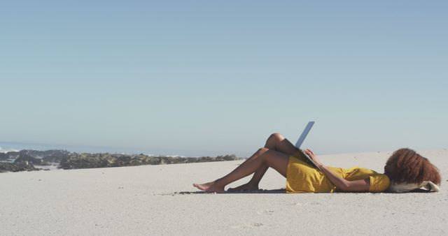 Young woman working on laptop relaxing on peaceful beach - Download Free Stock Images Pikwizard.com