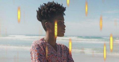 Elegant woman in patterned dress by tranquil ocean