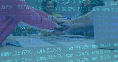 Diverse Team Celebrating Success with Stacked Hands in Office