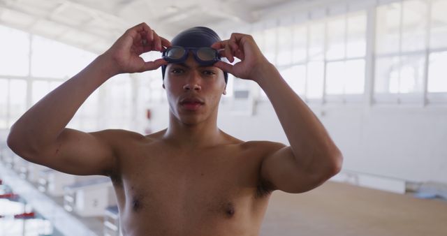 Confident Young Male Swimmer Preparing at Indoor Pool - Download Free Stock Images Pikwizard.com