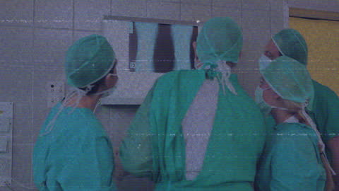 Medical Team Analyzing X-ray in Scrubs for Health Diagnostics