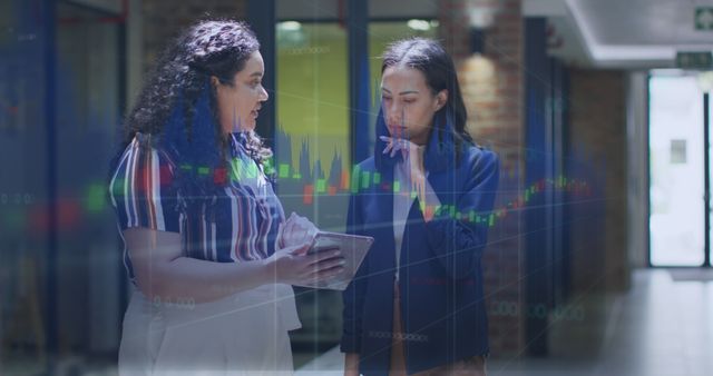 Businesswomen Analyzing Stock Market Data on Tablet in Office Corridor - Download Free Stock Images Pikwizard.com