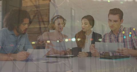 Young Professionals Discussing Financial Reports in Modern Office