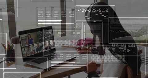 Working woman using laptop and smartphone with AR overlay for remote collaboration